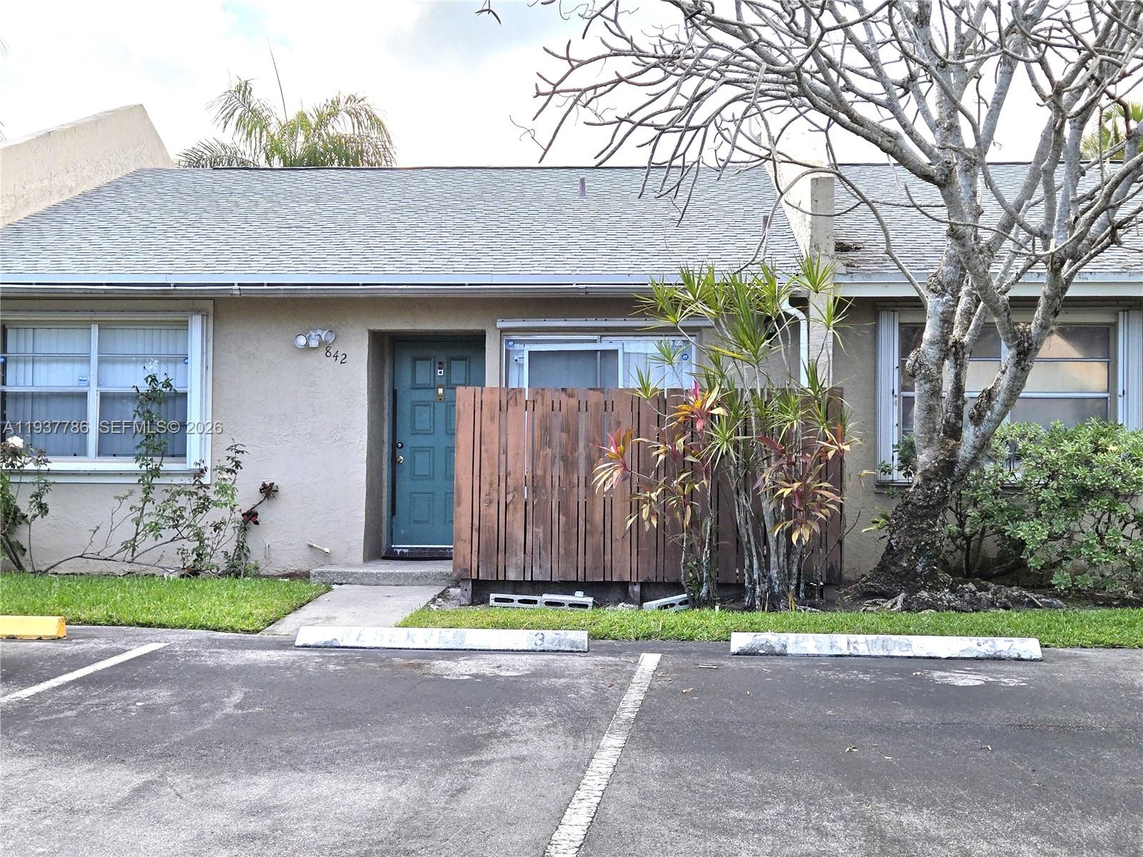 842 Banks Road Coconut Creek, FL 33063 - Photo 1 of 8 a front view of a house with garden