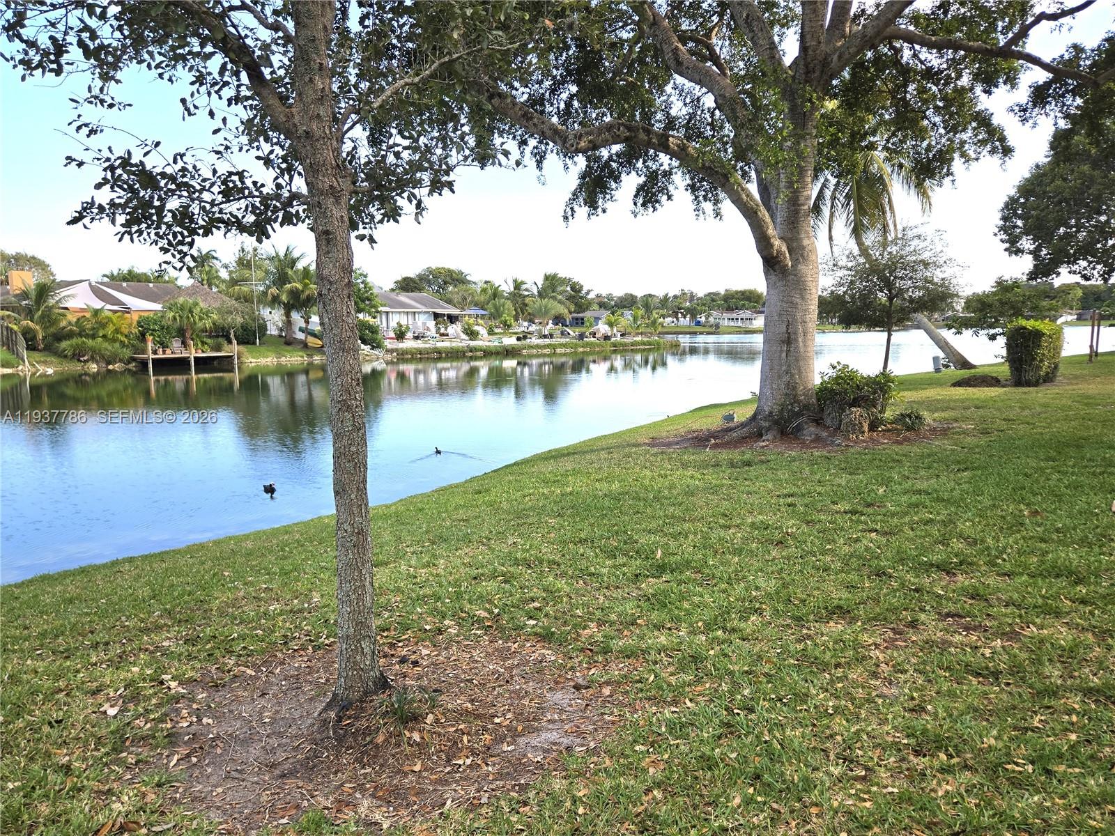 842 Banks Road Coconut Creek, FL 33063 - Photo 5 of 8 a view of a lake with houses