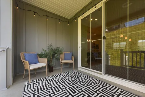 a living room with furniture and floor to ceiling window