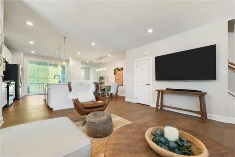 a living room with furniture dining table and a large window