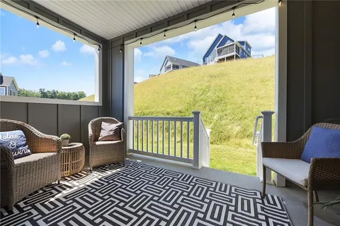 a view of a balcony with couch and wooden floor