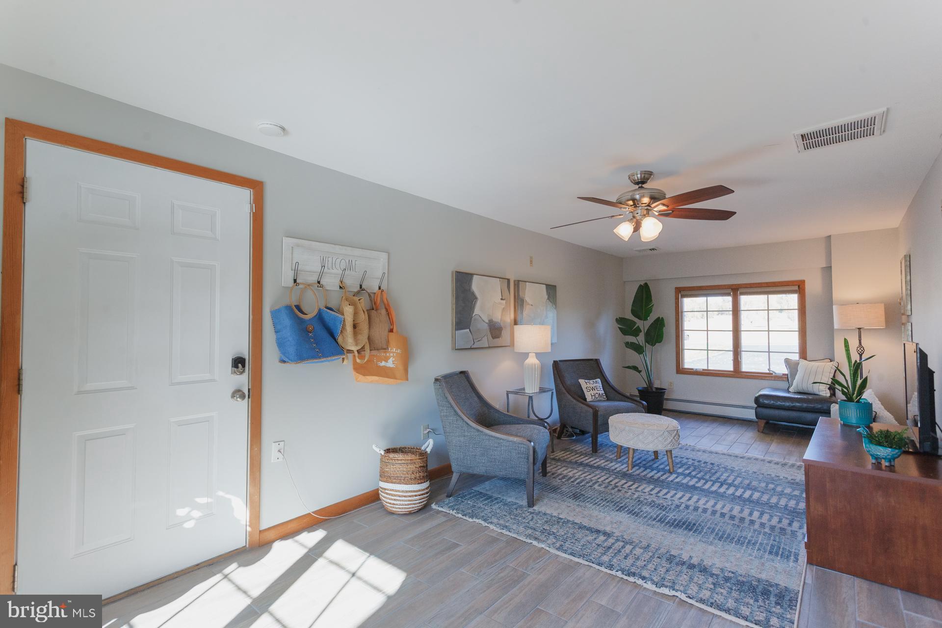 2017 Quarry Road Yardley, PA 19067 - Photo 12 of 37 a living room with furniture a lamp and a window