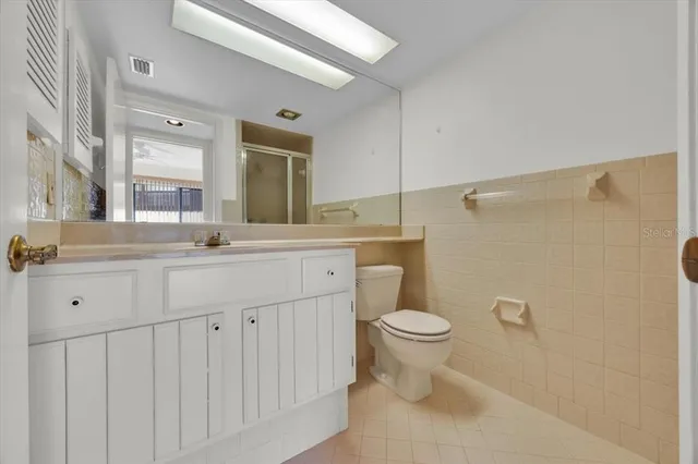 a bathroom with a double vanity sink mirror and toilet