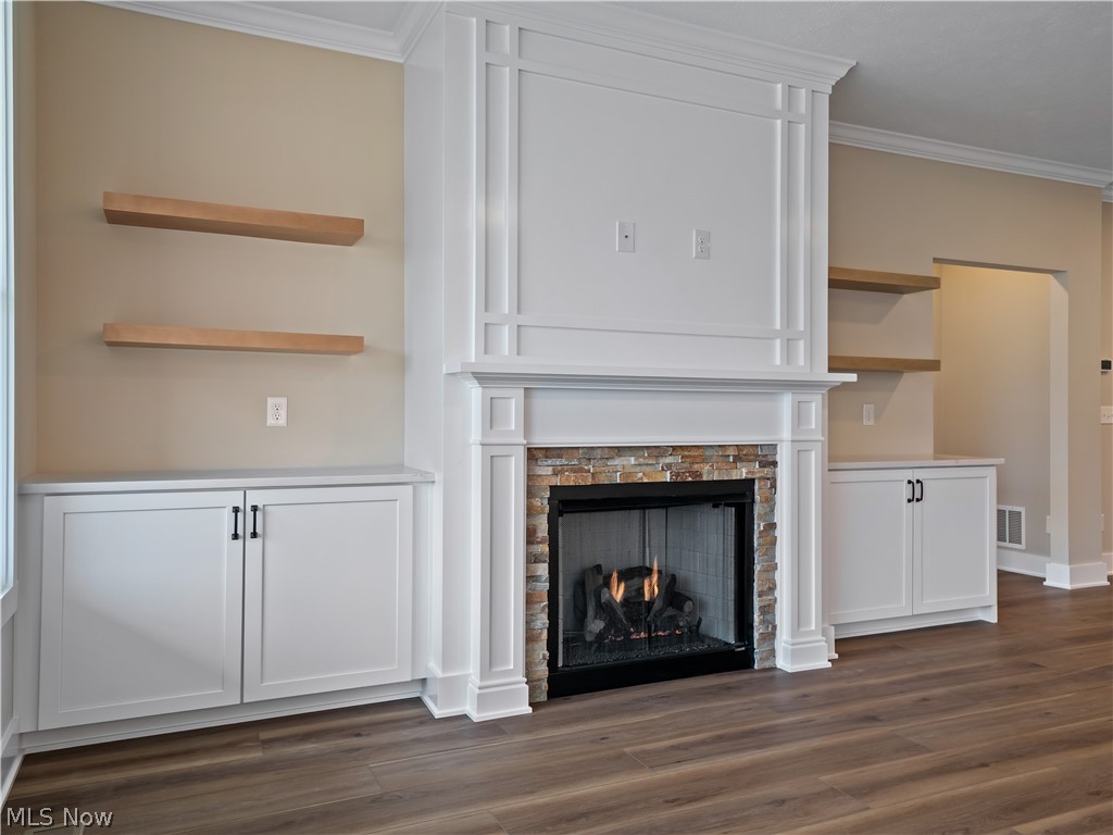 34270 Brookside Lane North Ridgeville, OH 44039 - Photo 6 of 50 Detailed view of ornamental molding, a stone fireplace, and wood finished floors