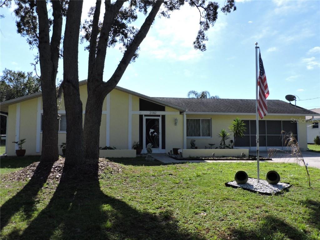 2182 Bishop Road Spring Hill, FL 34608 - Photo 1 of 1 a front view of a house with garden and porch