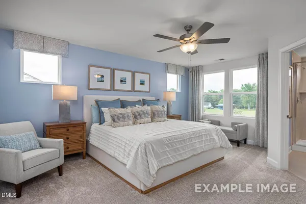 a bedroom with a large bed and a chandelier