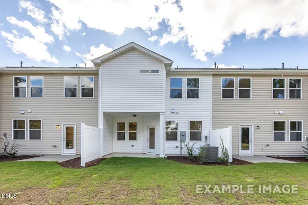 an view of a livingroom with furniture and a mirror