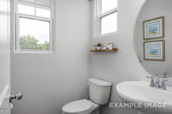 a view of bathroom with a toilet and a sink