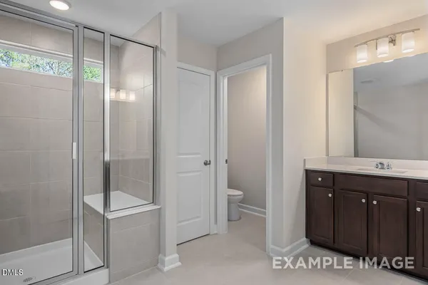 a bathroom with a double vanity sink toilet and shower