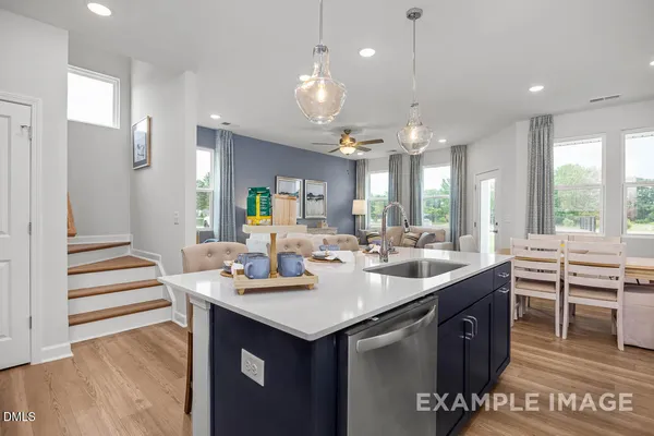 a kitchen with stainless steel appliances a white cabinets and a stove top oven