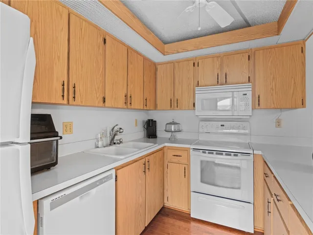 a kitchen with granite countertop cabinets stainless steel appliances and a sink