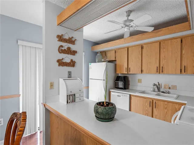 a kitchen with a sink a stove and a refrigerator