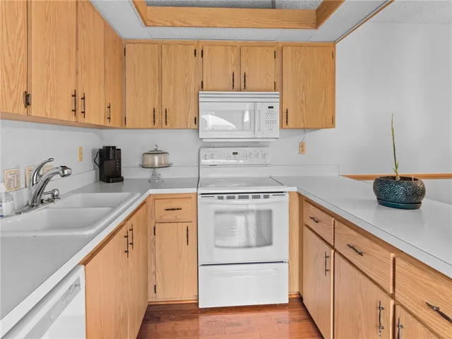 a kitchen with cabinets a sink and appliances