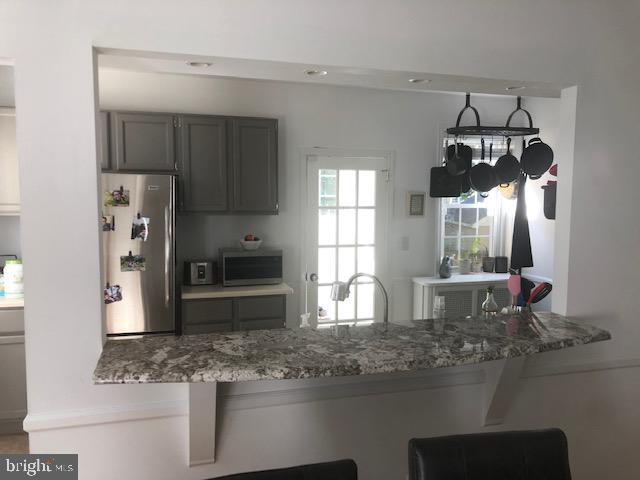 41 Chatham Road Ardmore, PA 19003 - Photo 9 of 20 a kitchen with stainless steel appliances kitchen island granite countertop a sink stove and refrigerator