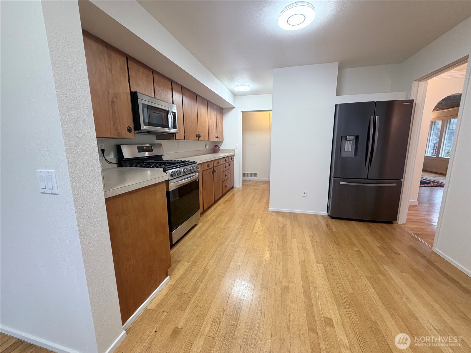 517 South 3rd Street McCleary, WA 98557 - Photo 11 of 38 a kitchen with stainless steel appliances granite countertop a refrigerator microwave and sink