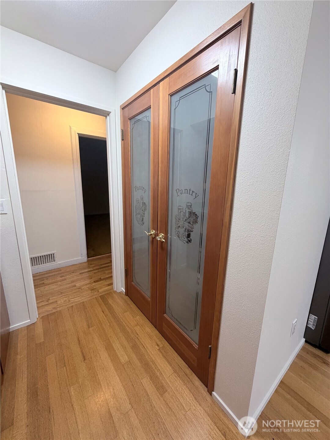 517 South 3rd Street McCleary, WA 98557 - Photo 14 of 38 an empty room with wooden floor and entrance