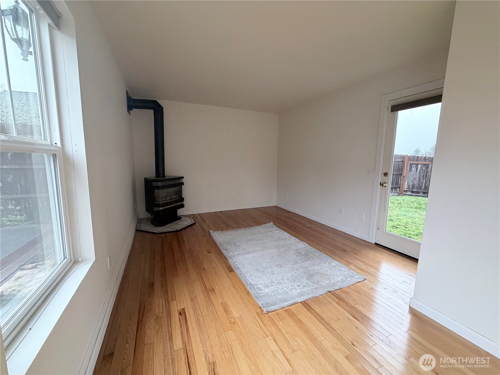 517 South 3rd Street McCleary, WA 98557 - Photo 17 of 38 a view of a bedroom with wooden floor and front door
