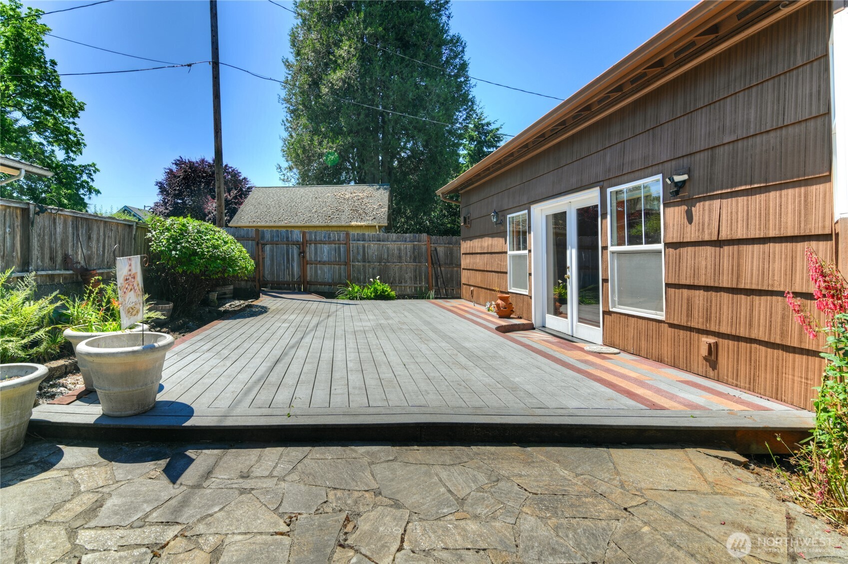 517 South 3rd Street McCleary, WA 98557 - Photo 35 of 38 a backyard of a house with potted plants and a bench