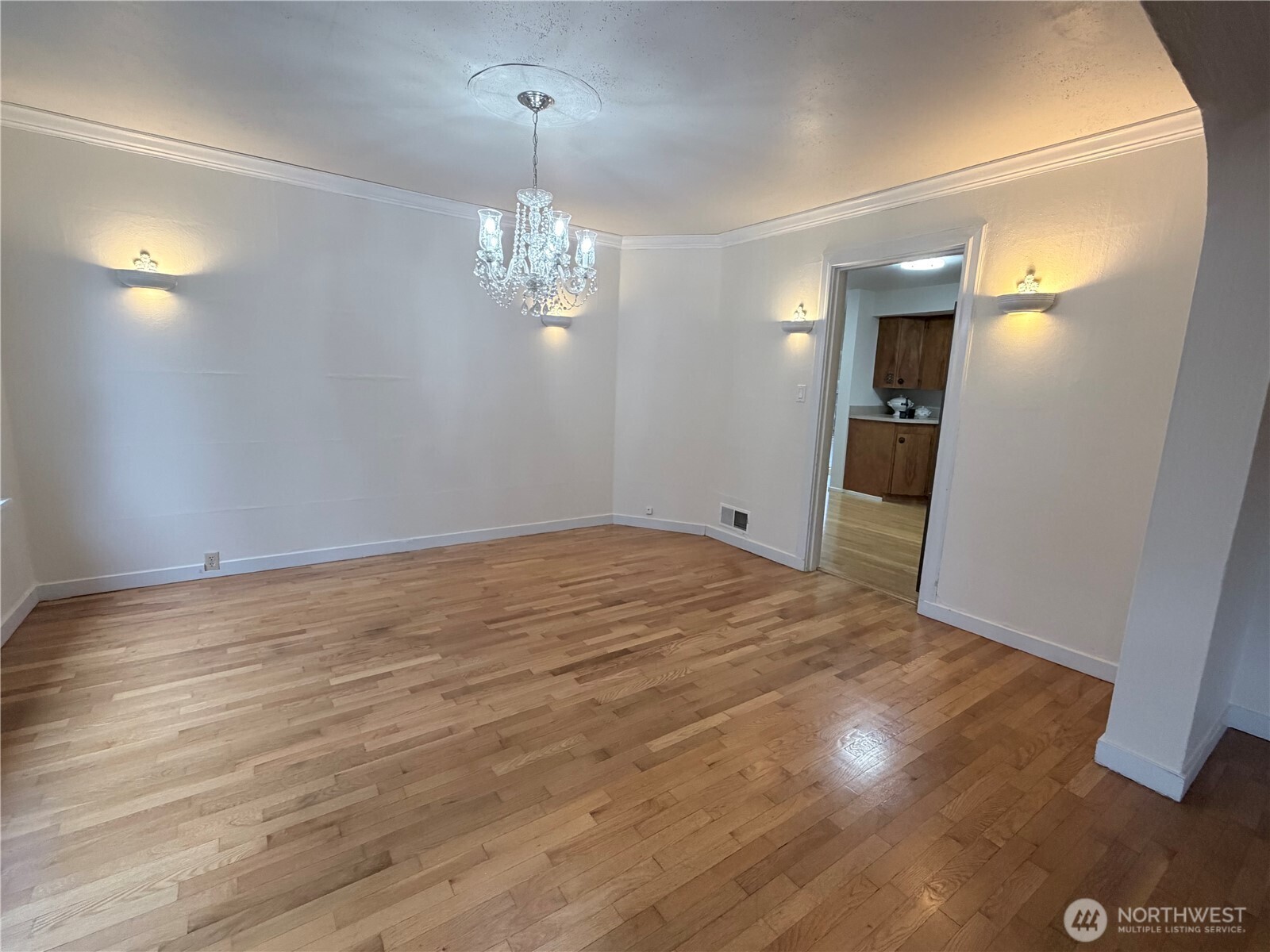 517 South 3rd Street McCleary, WA 98557 - Photo 9 of 38 an empty room with wooden floor and chandelier