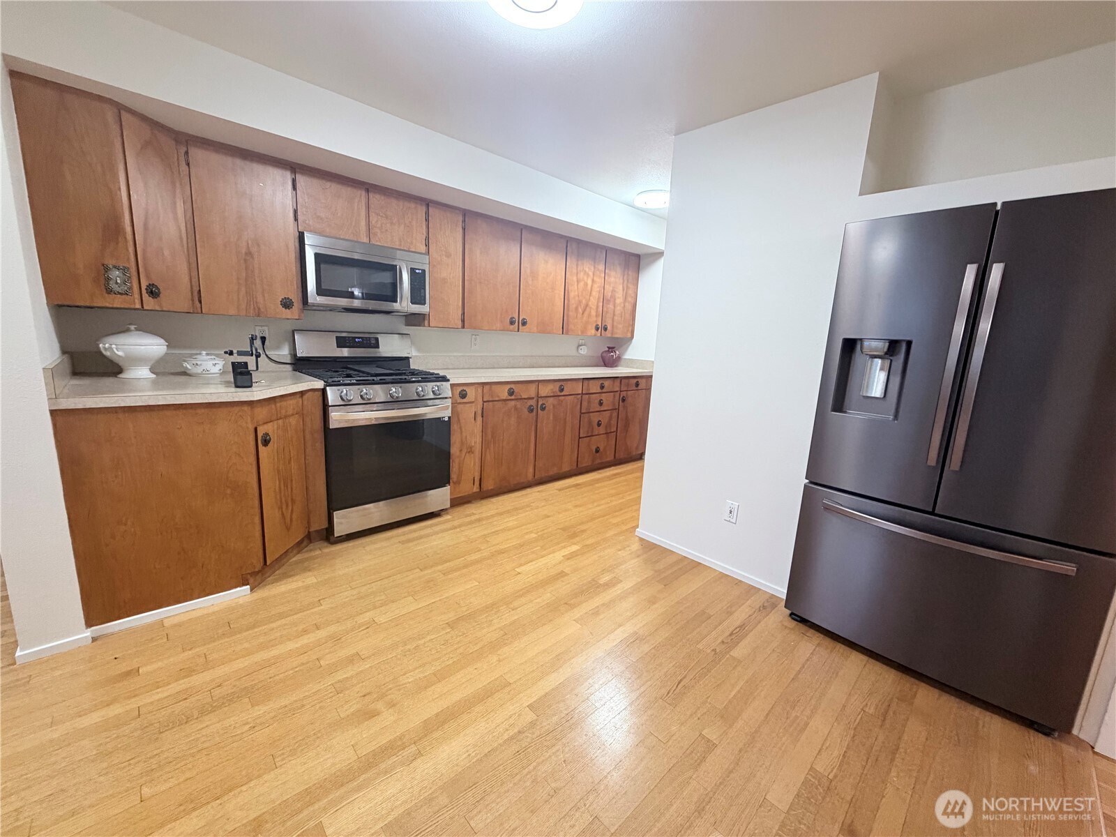 517 South 3rd Street McCleary, WA 98557 - Photo 10 of 38 a kitchen with stainless steel appliances granite countertop a refrigerator microwave and sink
