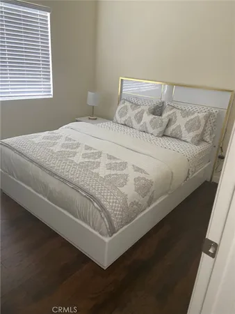 a bed sitting in a bedroom next to a window