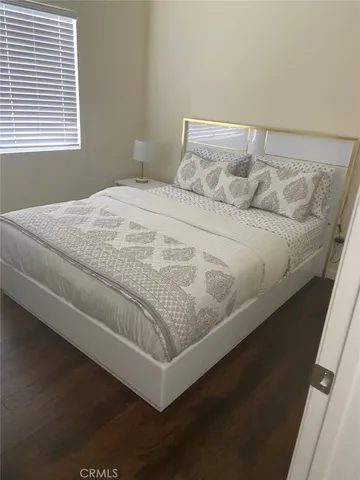 a bed sitting in a bedroom next to a window