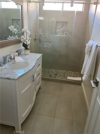 a bathroom with a granite countertop sink a toilet and a mirror