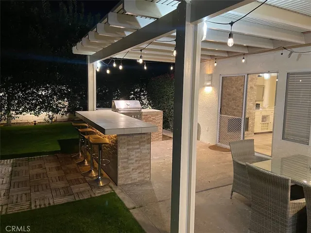 a view of living room and kitchen with a sink