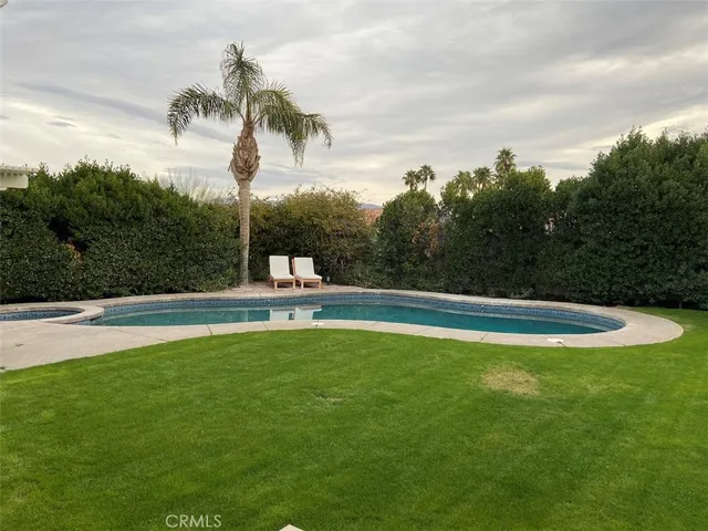 a view of a swimming pool with a yard