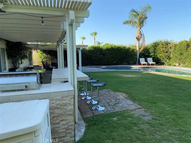 a view of a patio with a table chairs and a fire pit