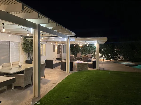 a view of a patio with table and chairs potted plants with large tree
