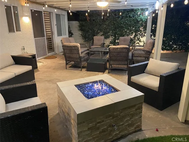 a outdoor living space with furniture and a fireplace