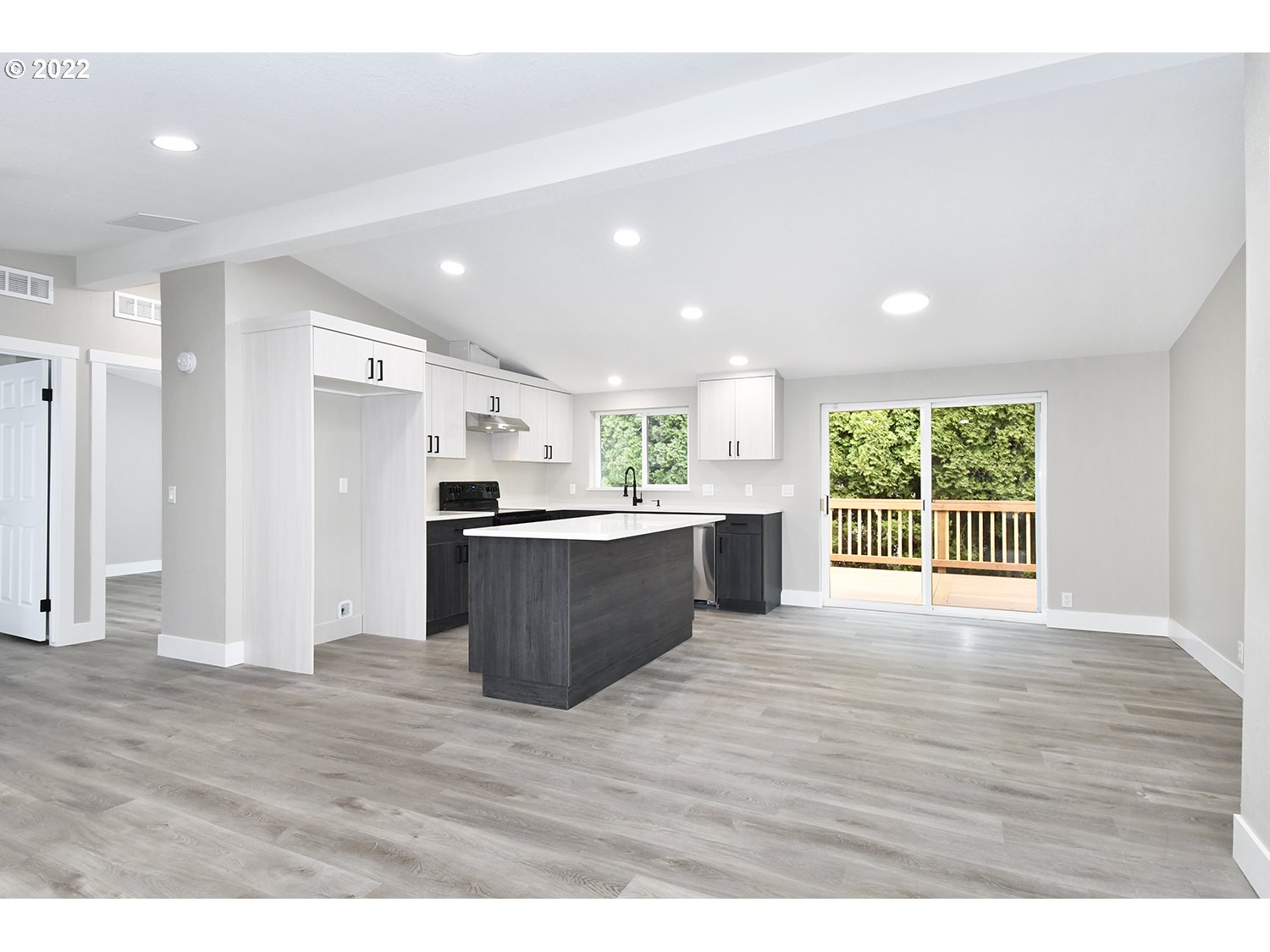 1465 Southeast Maple Loop Gresham, OR 97080 - Photo 11 of 32 a view of kitchen with kitchen island wooden floors appliances and cabinets