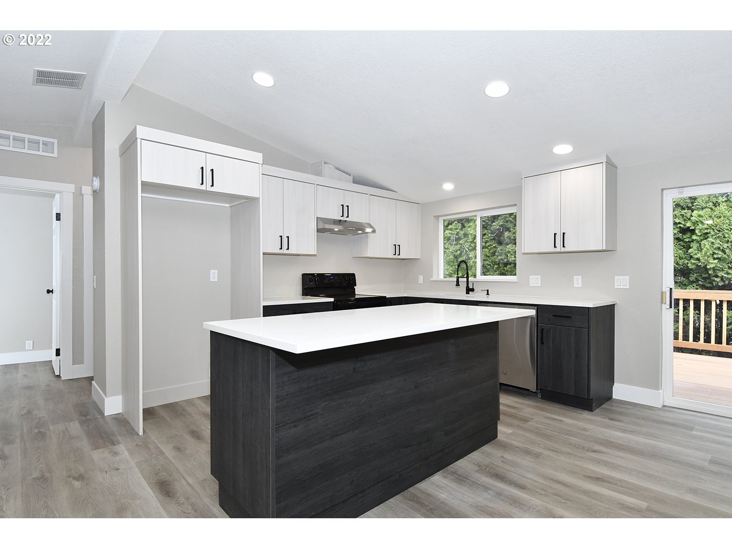 1465 Southeast Maple Loop Gresham, OR 97080 - Photo 12 of 32 a kitchen with a sink cabinets and wooden floor