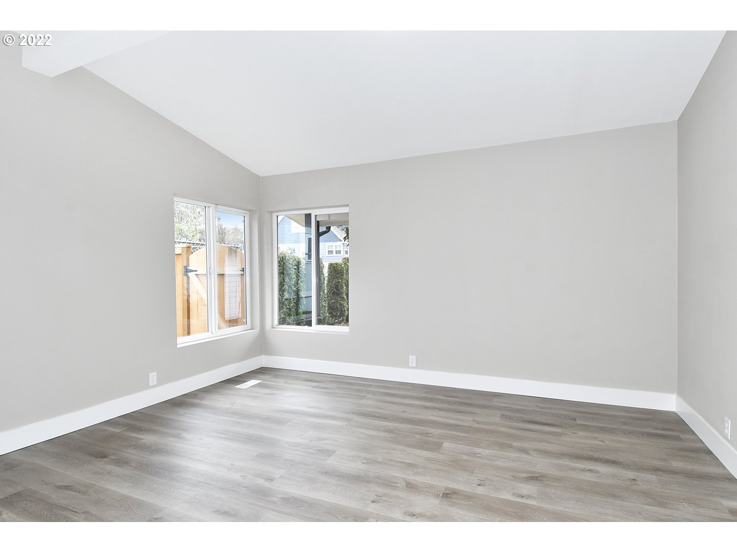 1465 Southeast Maple Loop Gresham, OR 97080 - Photo 15 of 32 a view of an empty room with wooden floor and a window