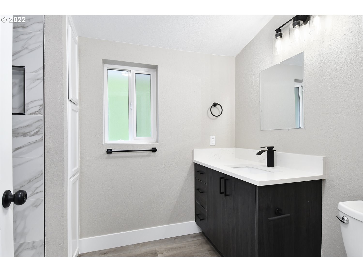 1465 Southeast Maple Loop Gresham, OR 97080 - Photo 17 of 32 a bathroom with a sink vanity and mirror