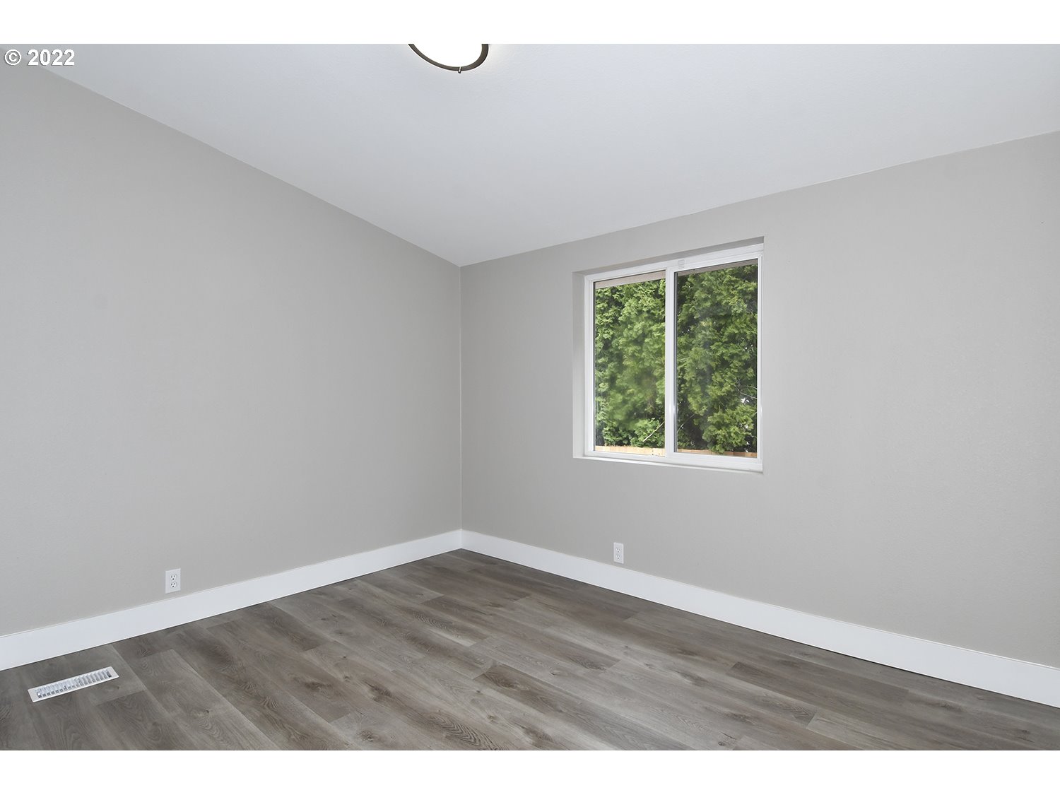 1465 Southeast Maple Loop Gresham, OR 97080 - Photo 22 of 32 an empty room with wooden floor and windows