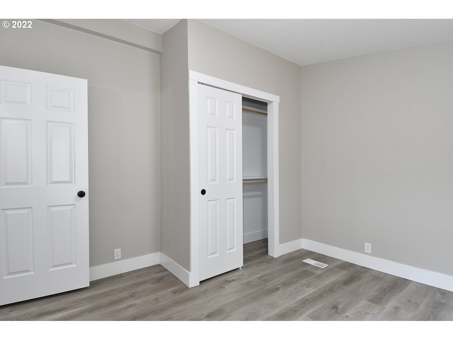 1465 Southeast Maple Loop Gresham, OR 97080 - Photo 23 of 32 a view of an empty room with closet and wooden floor
