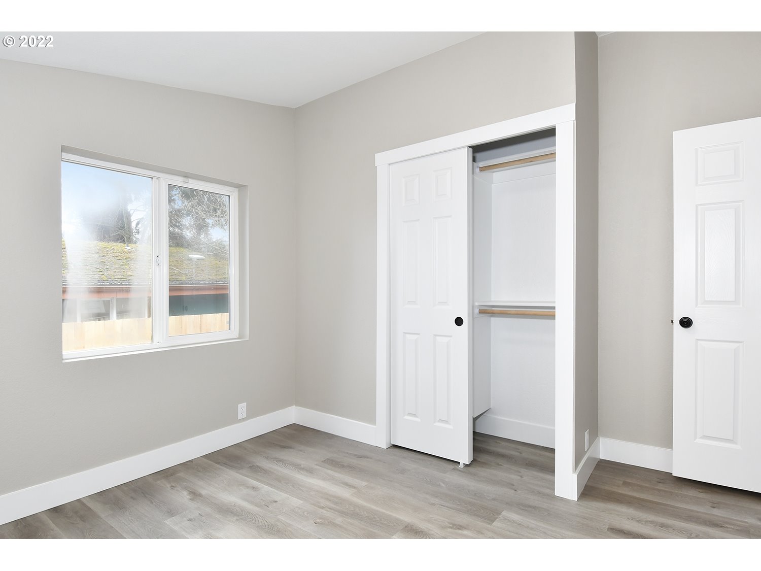 1465 Southeast Maple Loop Gresham, OR 97080 - Photo 25 of 32 a view of an empty room with wooden floor and a window