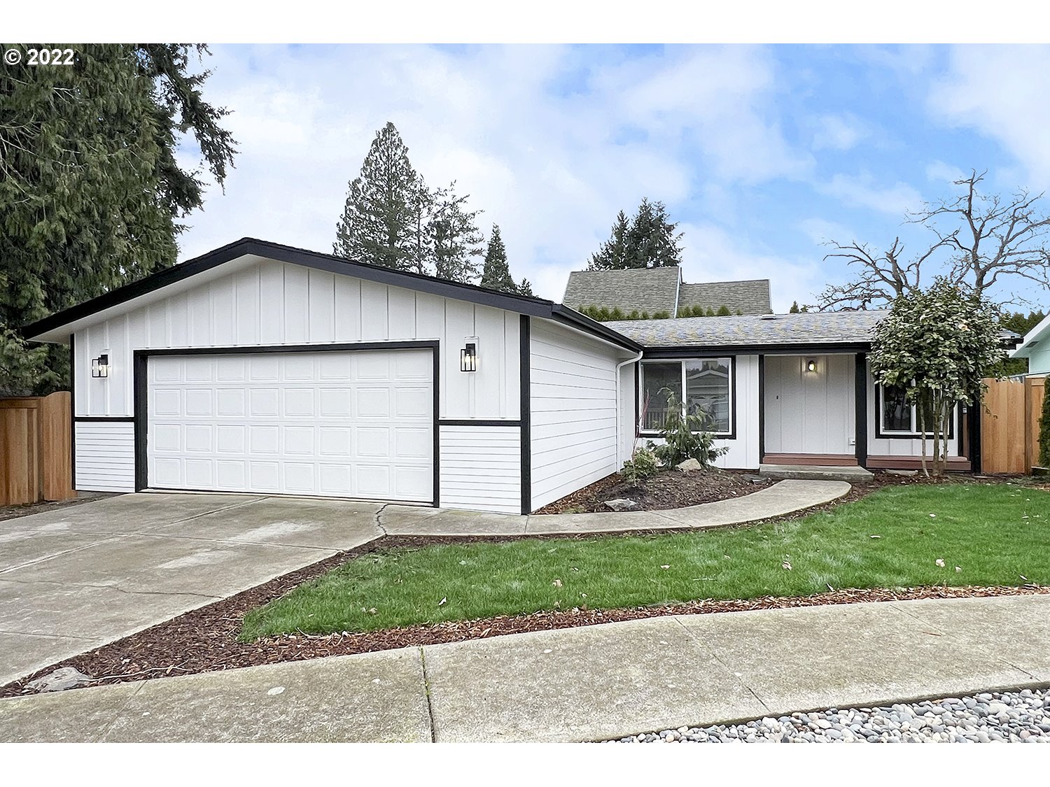 1465 Southeast Maple Loop Gresham, OR 97080 - Photo 4 of 32 a front view of a house with a yard and garage