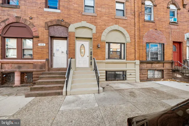 a view of a brick house with large windows