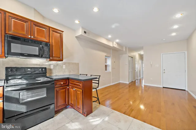 a kitchen with stainless steel appliances granite countertop a stove and a sink