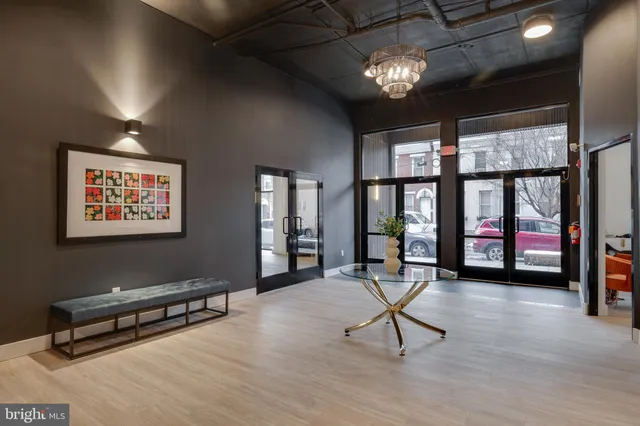 a view of a livingroom with furniture window and hardwood floor
