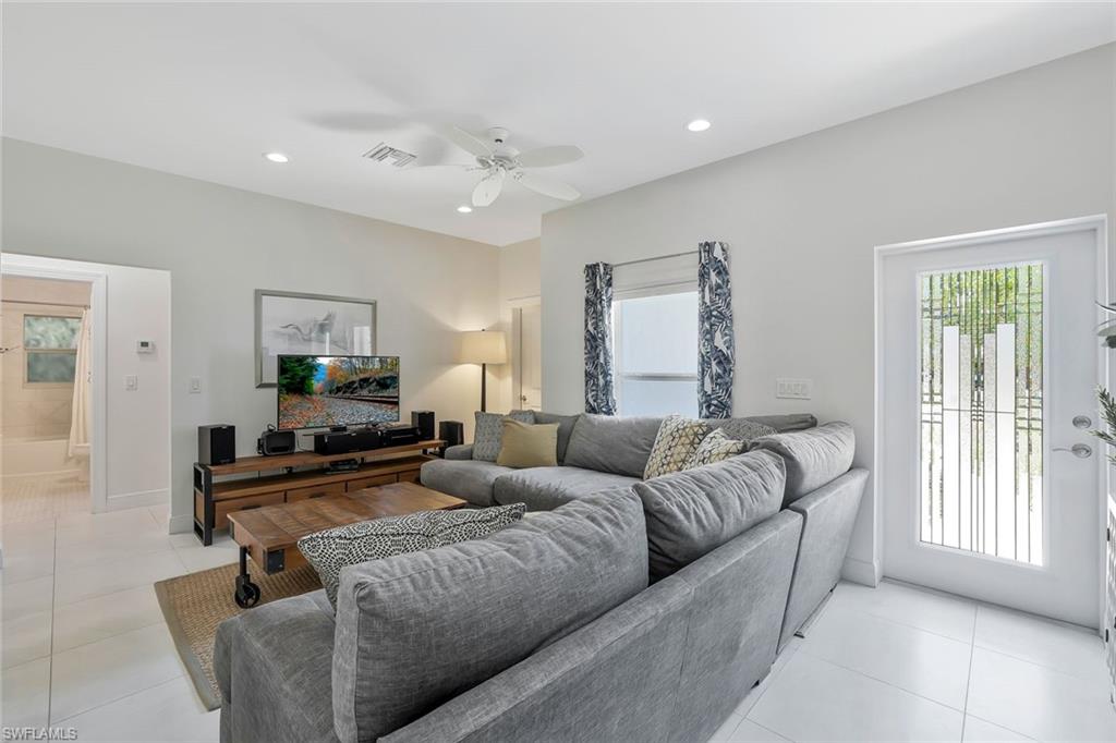 3892 14th Street North Naples, FL 34103 - Photo 13 of 19 a living room with furniture and a flat screen tv