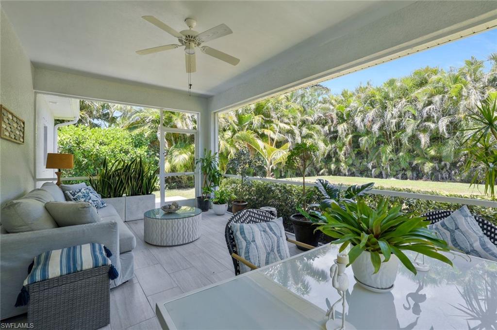 3892 14th Street North Naples, FL 34103 - Photo 14 of 19 a living room with patio furniture and a potted plant