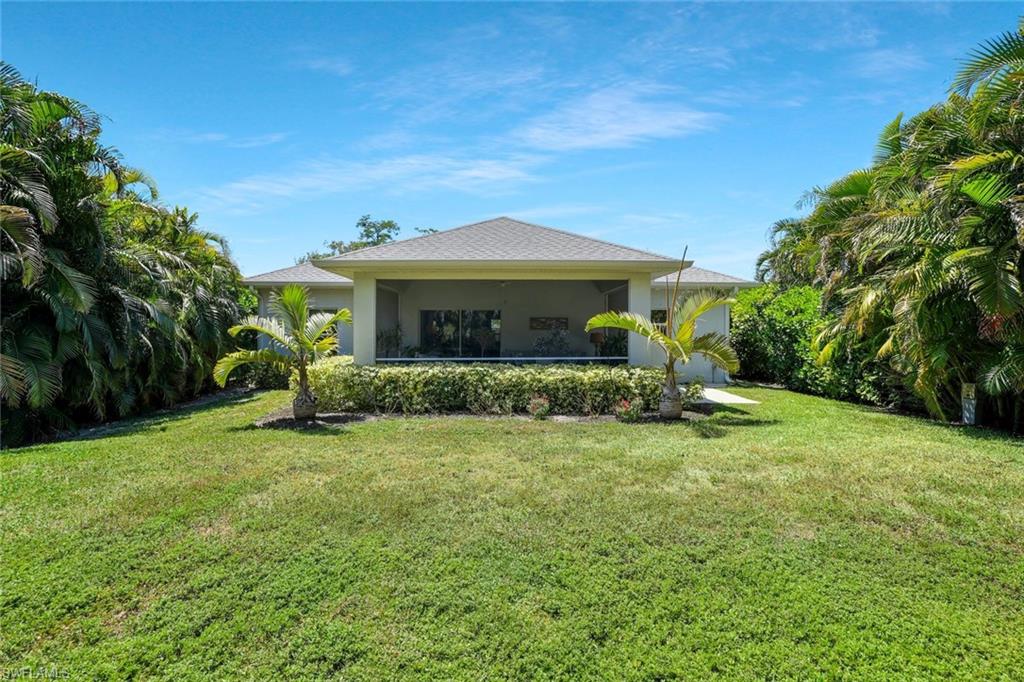 3892 14th Street North Naples, FL 34103 - Photo 15 of 19 a front view of a house with a yard