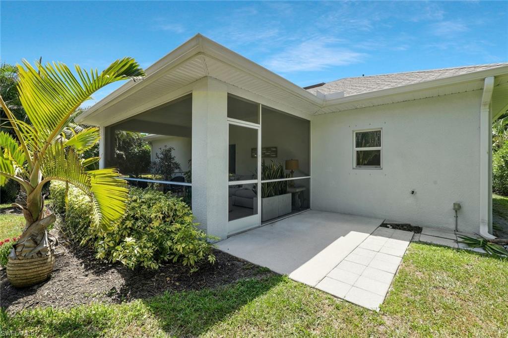 3892 14th Street North Naples, FL 34103 - Photo 16 of 19 a view of a house with a garden