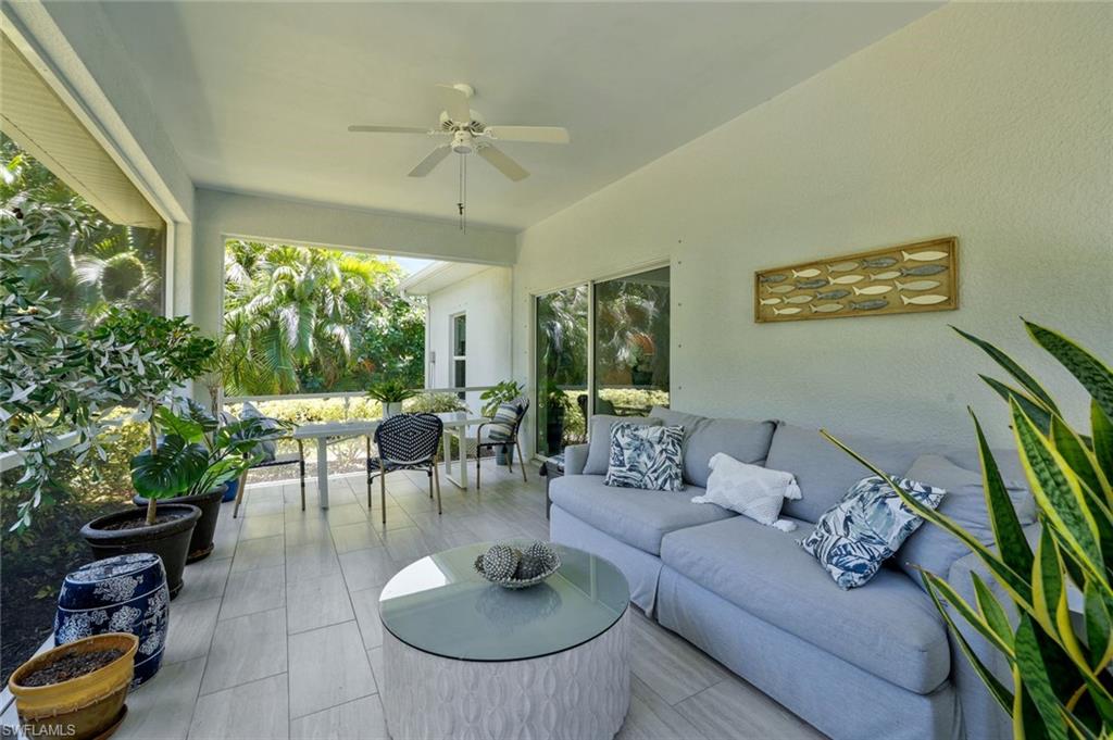 3892 14th Street North Naples, FL 34103 - Photo 2 of 19 a living room with furniture potted plant and a large window