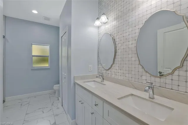 a bathroom with a double vanity sink and a mirror