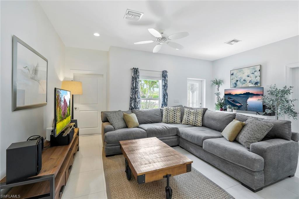3892 14th Street North Naples, FL 34103 - Photo 5 of 19 a living room with furniture and a flat screen tv